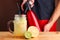 Male bartender make citrus cocktail. non alcoholic summer drinks with citrus on wooden table Siphon, a device for making soda