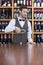 Male Bartender Pouring White Wine In Glass