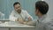 Male bearded doctor in clinic measure clients pressure