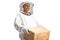 Male bee keeper holding a wooden box and smiling