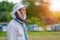 Male beekeeper over hives background. Protective hat. Blurred background. Honey and bees.