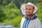 Male beekeeper over hives background. Protective hat. Blurred background. Honey and bees.