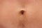 Male belly button on the stomach with black hair