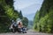 Male biker sitting on road near motorcycle