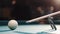 Male billiard player gets ready to stroke a ball with cue stick using rest