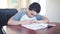 A male black child doing homework at home