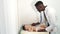 Male black doctor pediatrician examining baby at clinic