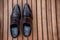 Male black shoes over the wooden table