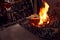 Male Blacksmith Lighting Wood Kindling To Start Blaze In Forge