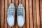 Male blue shoes over the wooden table