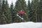 Male boarder on the snowboard jumping over the slope