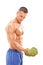 Male bodybuilder exercising with a broccoli dumbbell
