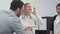 Male boss instructing two female coworkers during office meeting