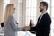 Male boss shake hand of female employee congratulate with promotion