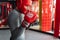 Male boxer engaged in training in the gym, in a cage for a fight without rules, Boxing coach