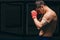 Male boxer getting concentrated, puts fists on foreground, ready to big fight