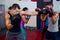 Male boxer and instructor practicing with boxing