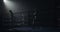 Male boxer training in the dark ring. Slow motion. Silhouette. Boxing concept.