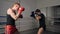 Male boxers training leg blows on boxing ring. Two boxer man fighting on ring. Male training high leg kicks on thai