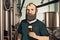 male brewer with glass of beer at a modern brewery. Cartoon style. Generative AI