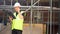 Male builder foreman construction worker on building site talking on cell phone