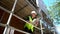 Male builder foreman construction worker on building site wearing a hardhat writing on clipboard