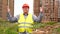 Male builder foreman, worker or architect on construction building site proudly shows results while raising his arms