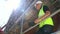 Male builder foreman, worker or architect working on construction building site standing on scaffolding