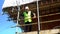 Male builder foreman, worker, surveyor or architect working on construction building site standing on scaffolding