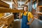 Male builder holds wooden boards in hardware store