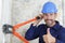 Male builder using bolt cropper with thumbs-up