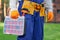 Male builder wearing tool belt carrying toolbox at construction site. Close up on waist area