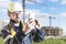 A male builder in a white hard hat against a blurred background of a construction site with a blue sky. Positive civil engineer