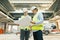 Male building workers working at construction site, builders looking in blueprint. Building, development, teamwork and people