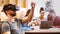 Male business executive using virtual reality headset while colleagues interacting at desk