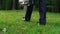 Male in business suit putting down briefcase on grass walking away, freedom