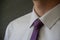 Male businessman with purple tie suits up. Close up of a young successful man in a white shirt