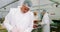 Male butcher maintaining records on clipboard