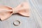 Male butterfly with a wedding ring on a wooden background