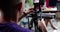 A male cameraman filming a woman in the office, close-up