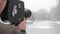 A male cameraman shoots video on an old vintage camera Krasnogorsk in the park in winter. Kyiv. Ukraine