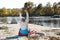 Male camper stretching in sleeping bag on wild beach.