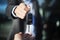 Male car dealer dressed in a suit giving car keys to a female person, focus on hands