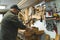 male carpenter creating wooden product by using a drawshape, medium shot, workshop