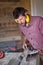 Male Carpenter cutting plank by circular saw