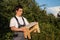 A male carpenter is holding a wooden stool