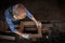 male carpenter uses sandpaper to polish the woodwork