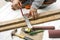 Male carpenter working with wood pencil and tools at work place. Background craftsman tool