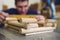 A male carpenter works with a tree in a carpentry shop. Making a mock-up of a log house