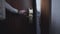 Male Caucasian hand opening door, wife and husband entering hotel room. Unrecognizable adult man and woman arriving in